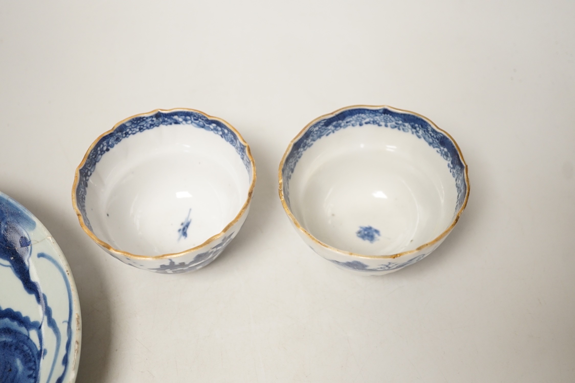 Two 19th century Chinese blue and white dishes and two 18th century tea bowls, largest 23cm diameter